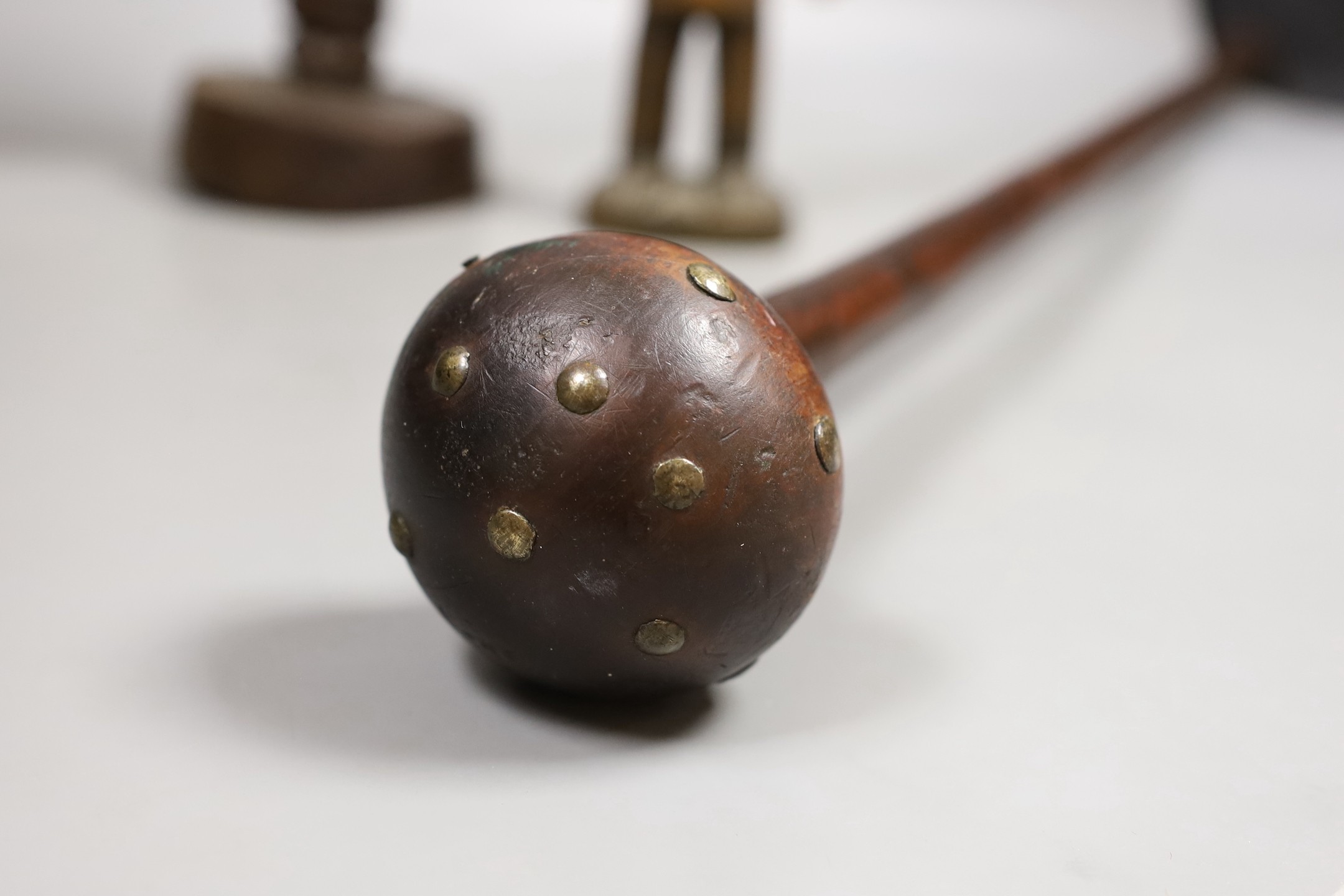 A Zulu knobkerrie, an Ibeji wood figure and a Gabon Fanti fertility figure- Knobkerrie 73 cms long.